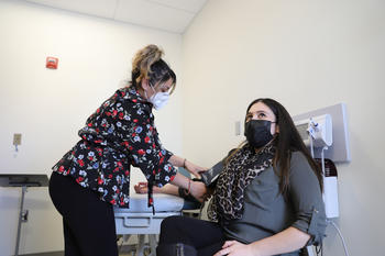 Image of nurse checking patient's blood pressure